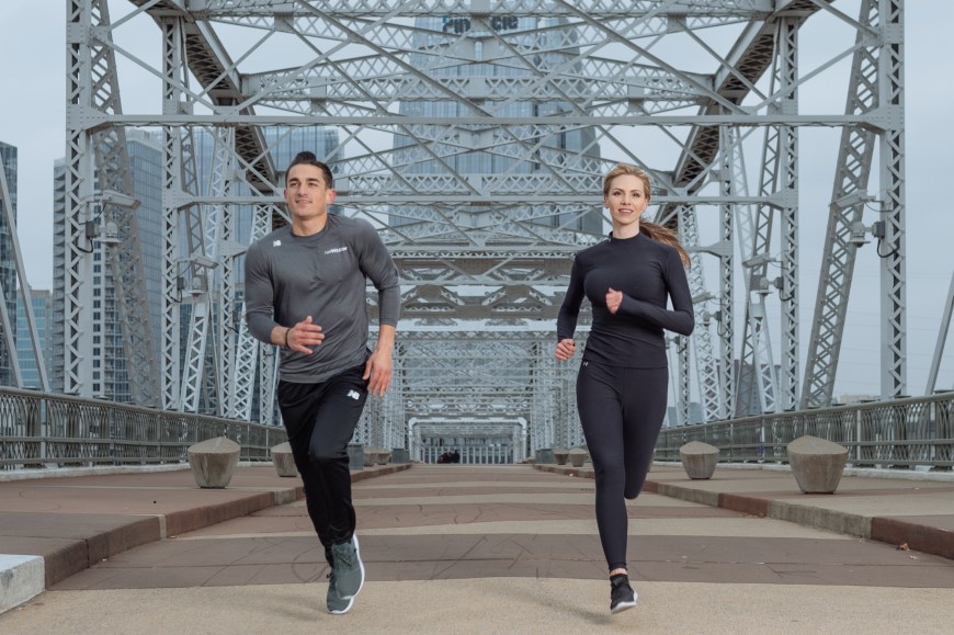 Two runners photographed by Tausha Dickinson running on the pedestrian bridge in Nashville, TN for the runWESTIN program.